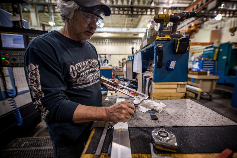 Machinist Mark Hutton uses hand calipers